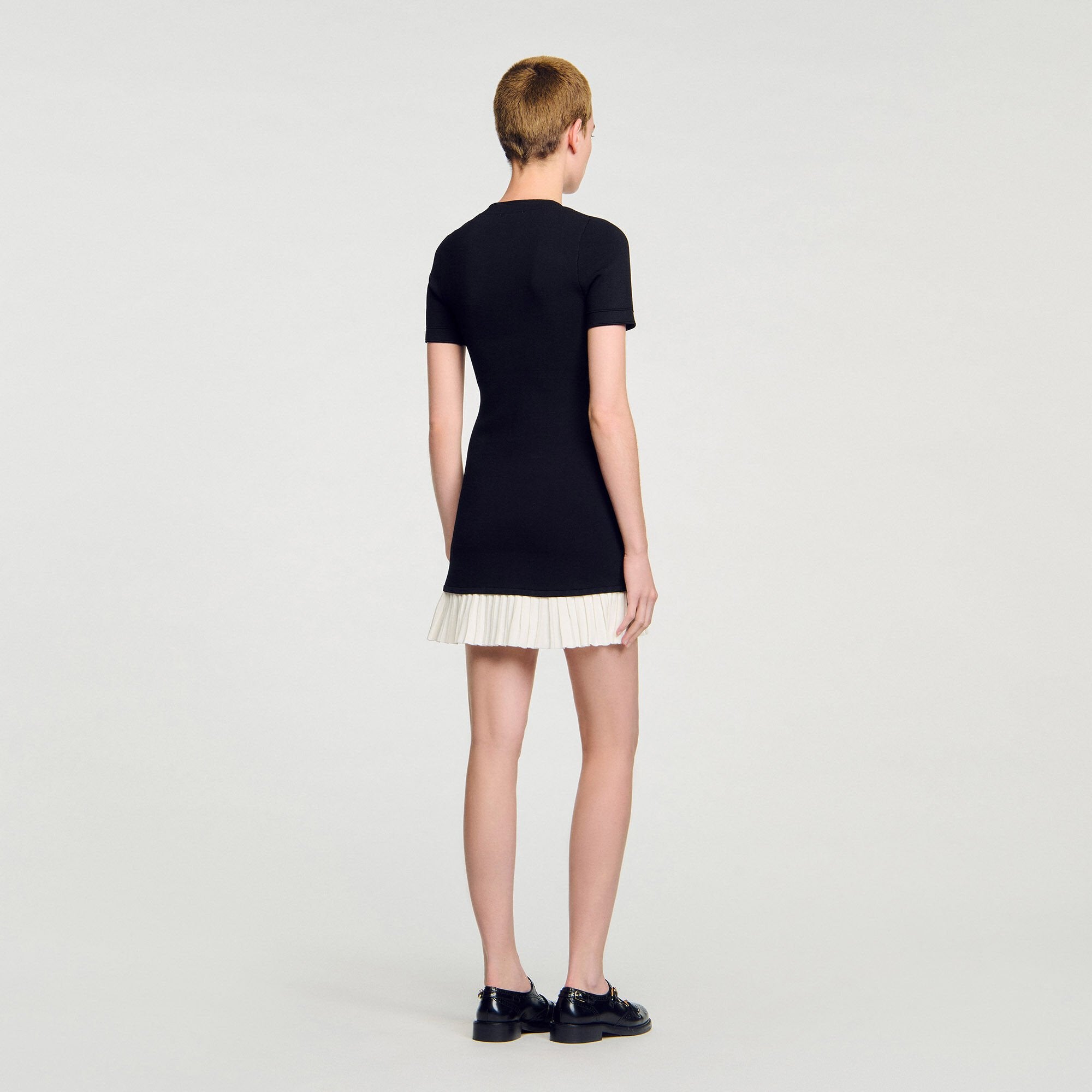 Sandro / Mini knit dress with ruffle Black / Ecru